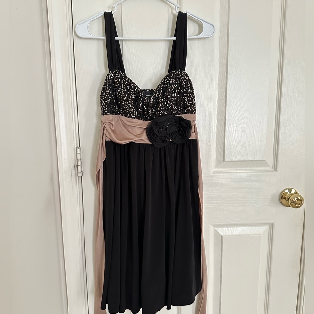 Formal black dress with sequins top, black flowers, and taupe tie in the back